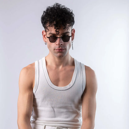 A male model wearing Exposure Sunglasses polarized sunglasses with black frames and black lenses, posing against a white background.
