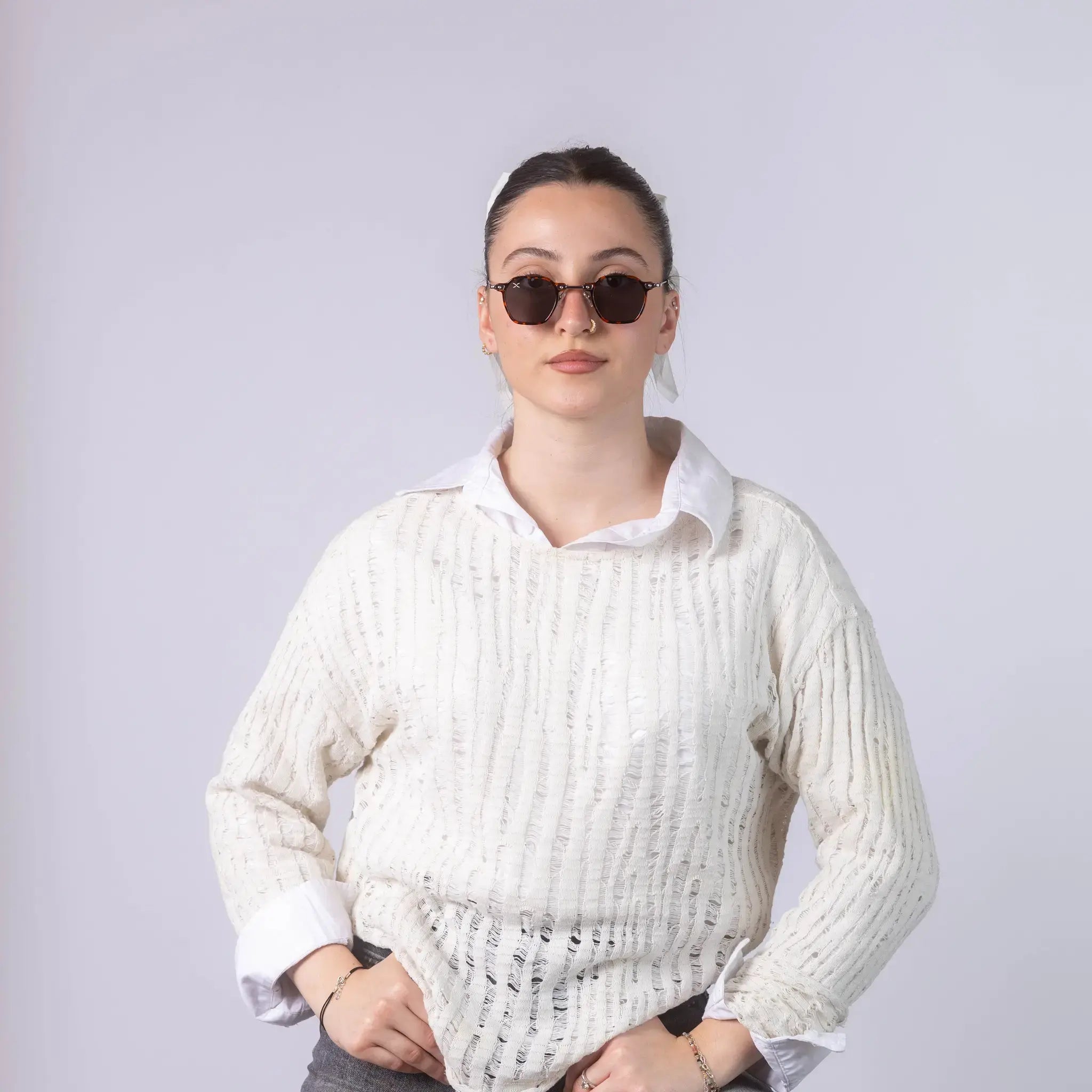 A female model wearing Exposure Sunglasses polarized sunglasses with brown frames and black lenses, posing against a white background.