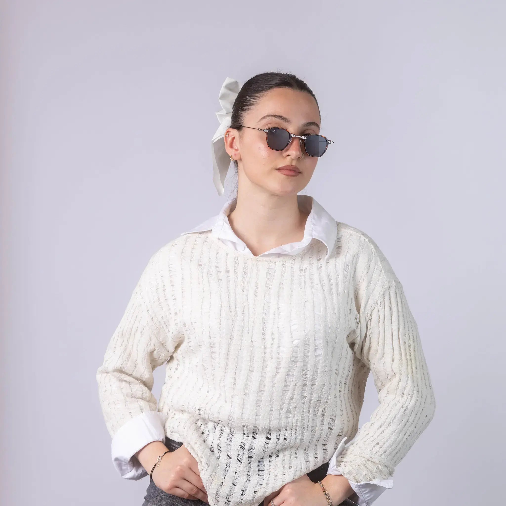 A female model wearing Exposure Sunglasses polarized sunglasses with brown frames and black lenses, posing against a white background.