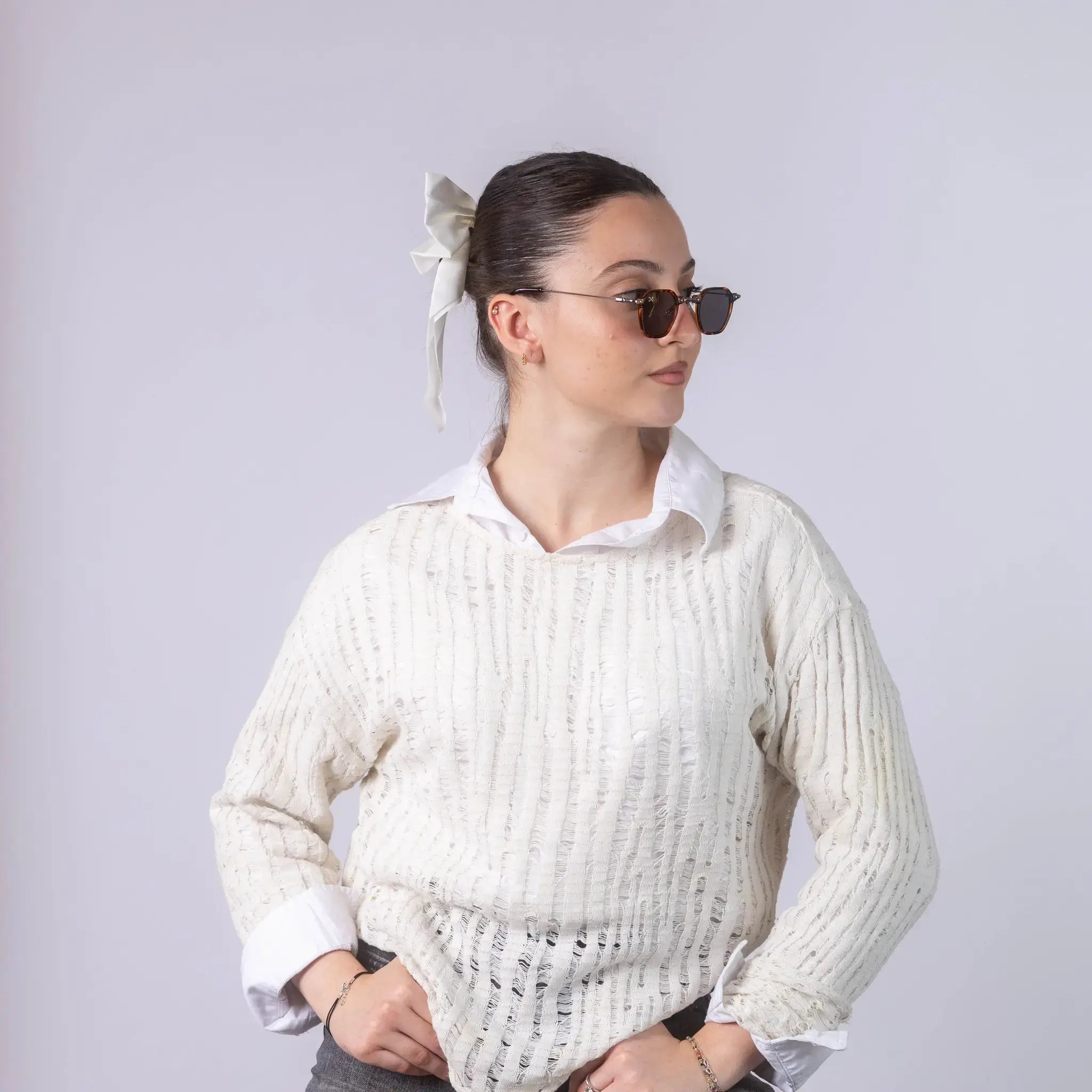 A female model wearing Exposure Sunglasses polarized sunglasses with brown frames and black lenses, posing against a white background.