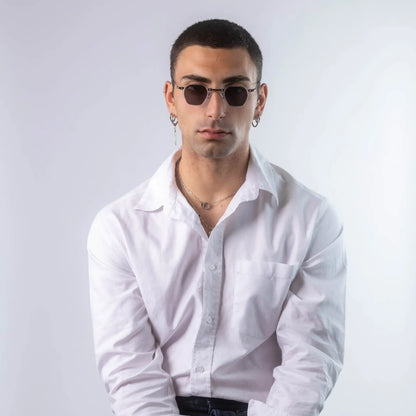A male model wearing Exposure Sunglasses polarized sunglasses with white frames and black lenses, posing against a white background.
