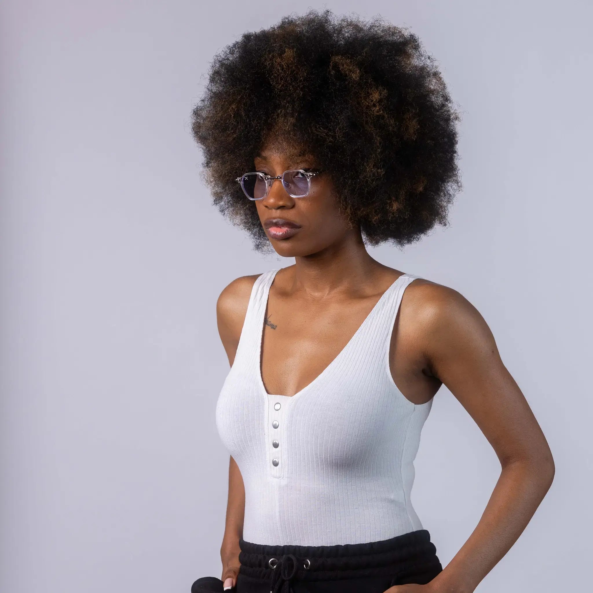 A female model wearing Exposure Sunglasses polarized sunglasses with white frames and blue lenses, posing against a white background.