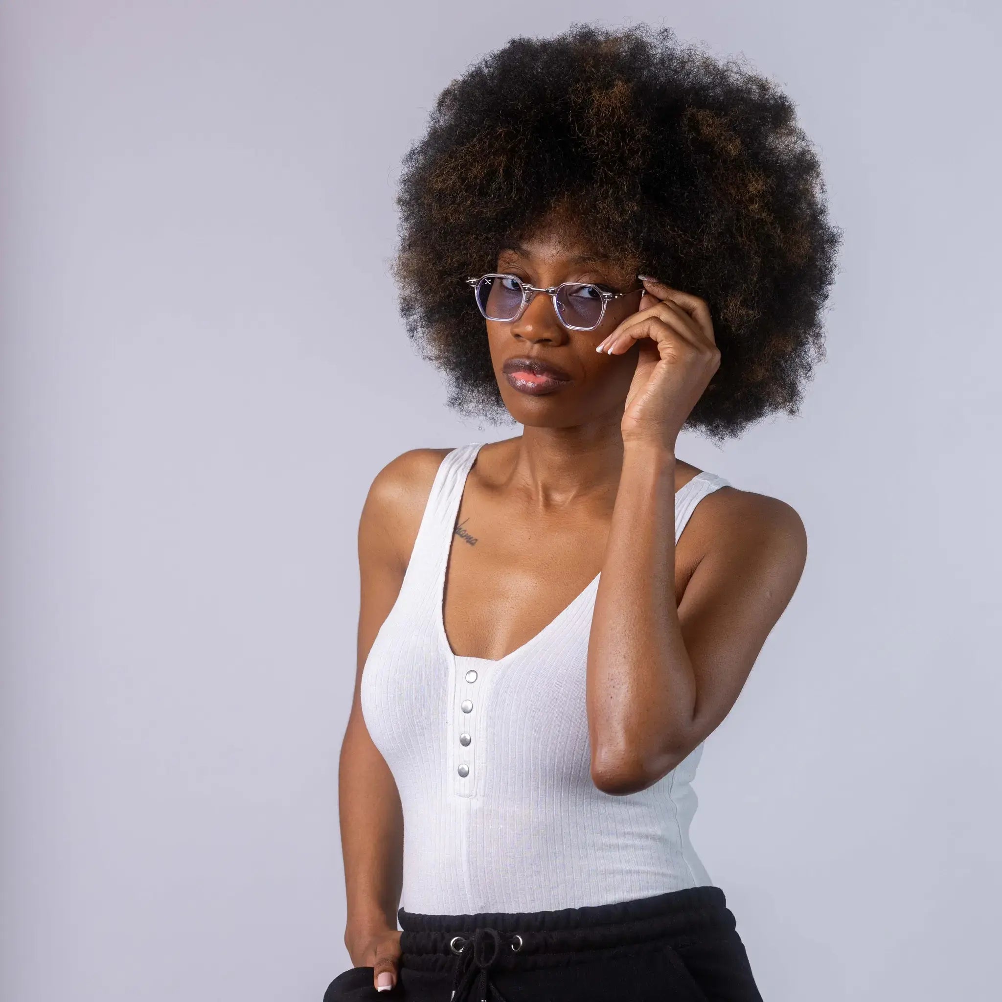 A female model wearing Exposure Sunglasses polarized sunglasses with white frames and blue lenses, posing against a white background.