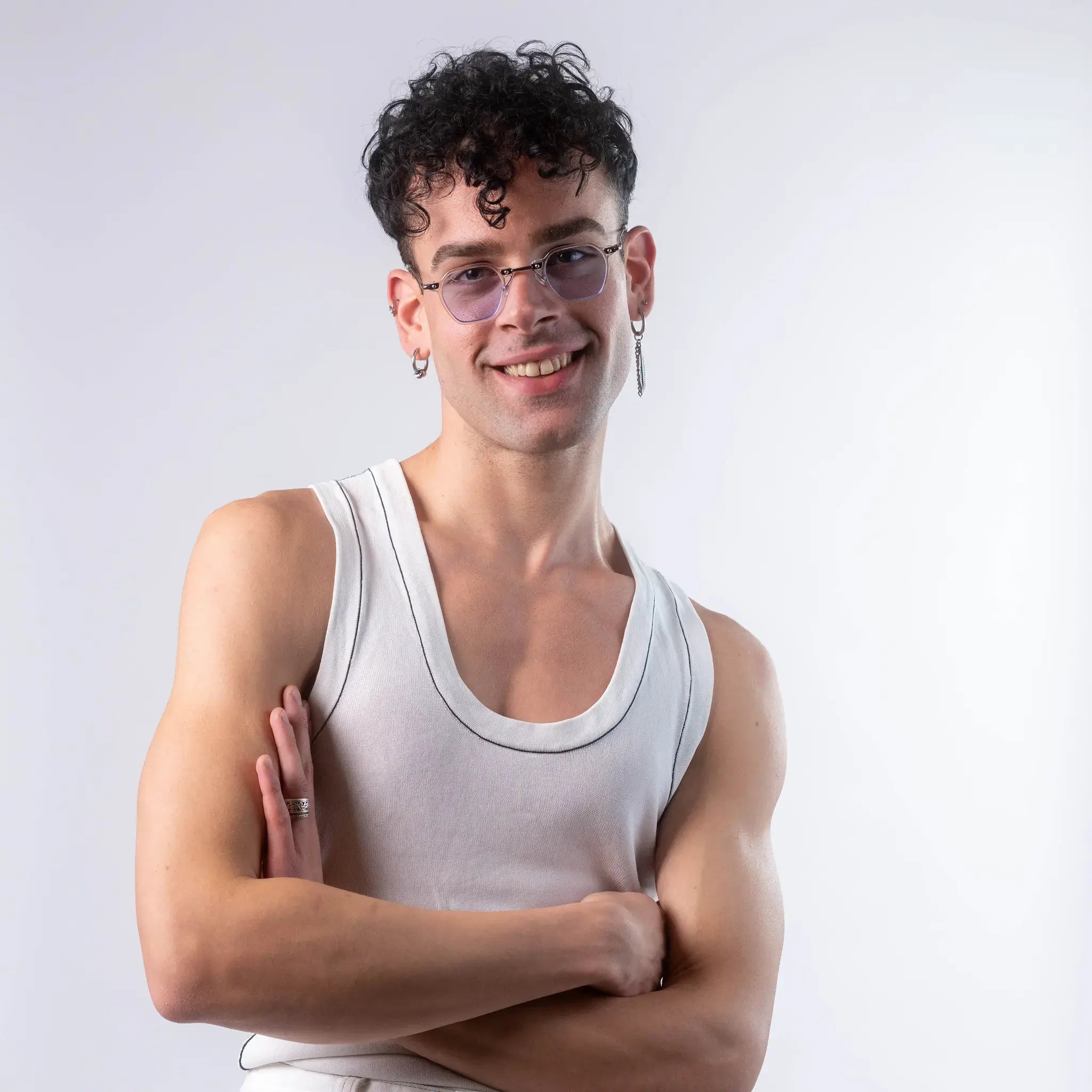 A male model wearing Exposure Sunglasses polarized sunglasses with white frames and blue lenses, posing against a white background.