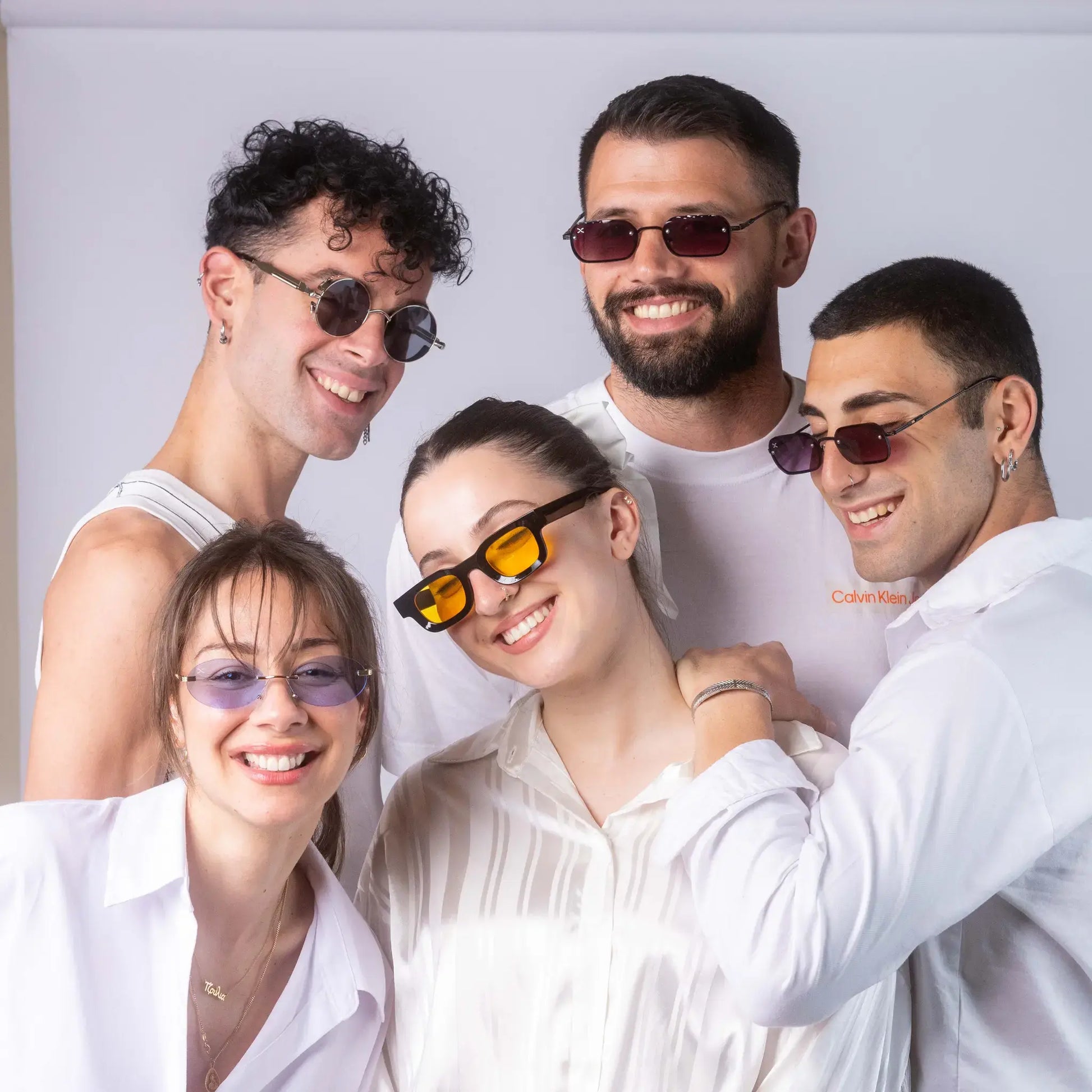 Five models wearing Exposure Sunglasses polarized sunglasses with silver frames and tinted lenses.