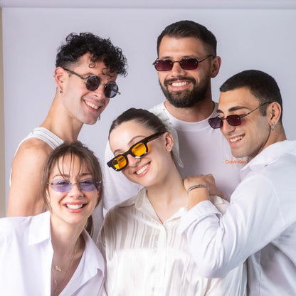 Five models wearing Exposure Sunglasses polarized sunglasses with silver frames and tinted lenses.