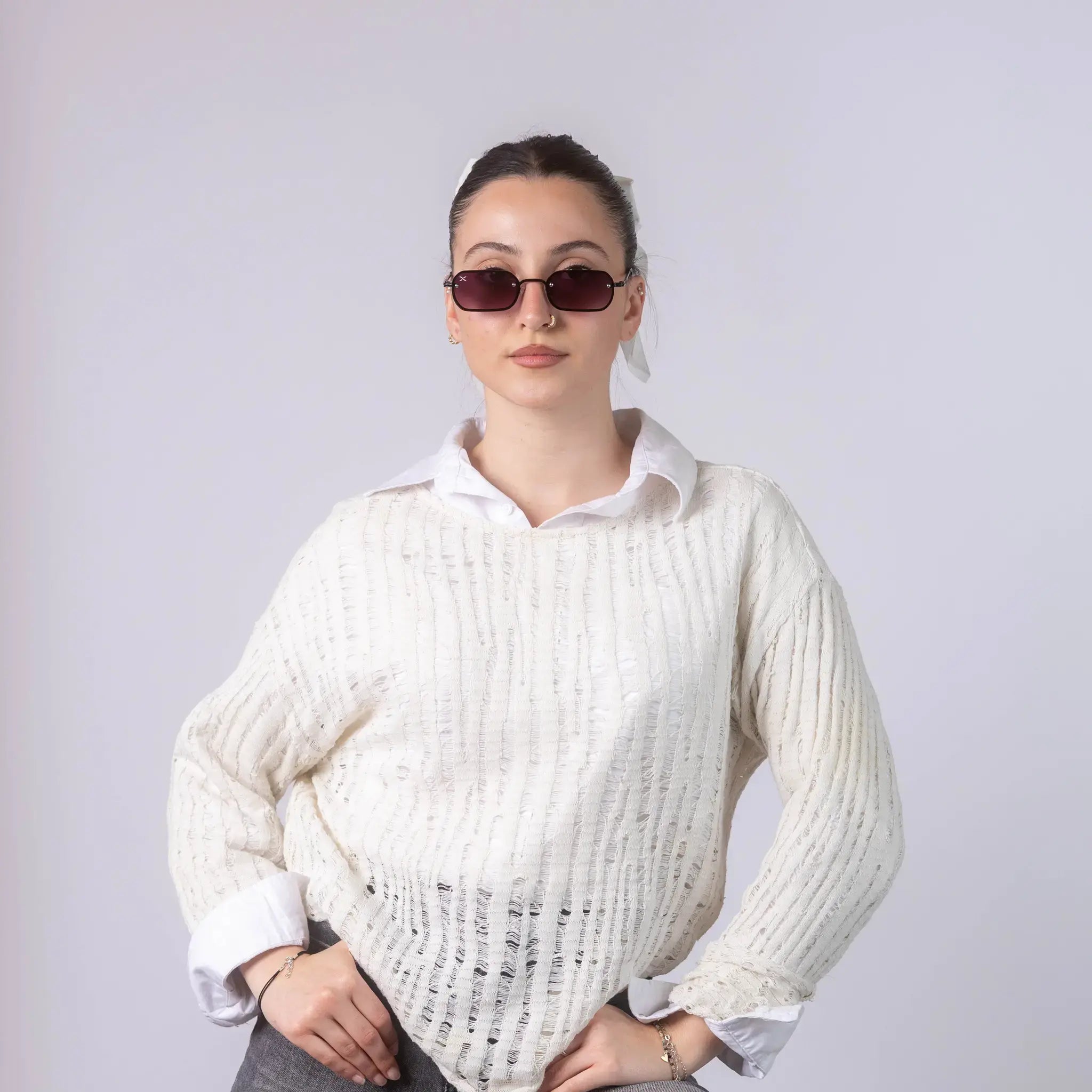 A female model wearing Exposure Sunglasses polarized sunglasses with black frames and purple lenses, posing against a white background.