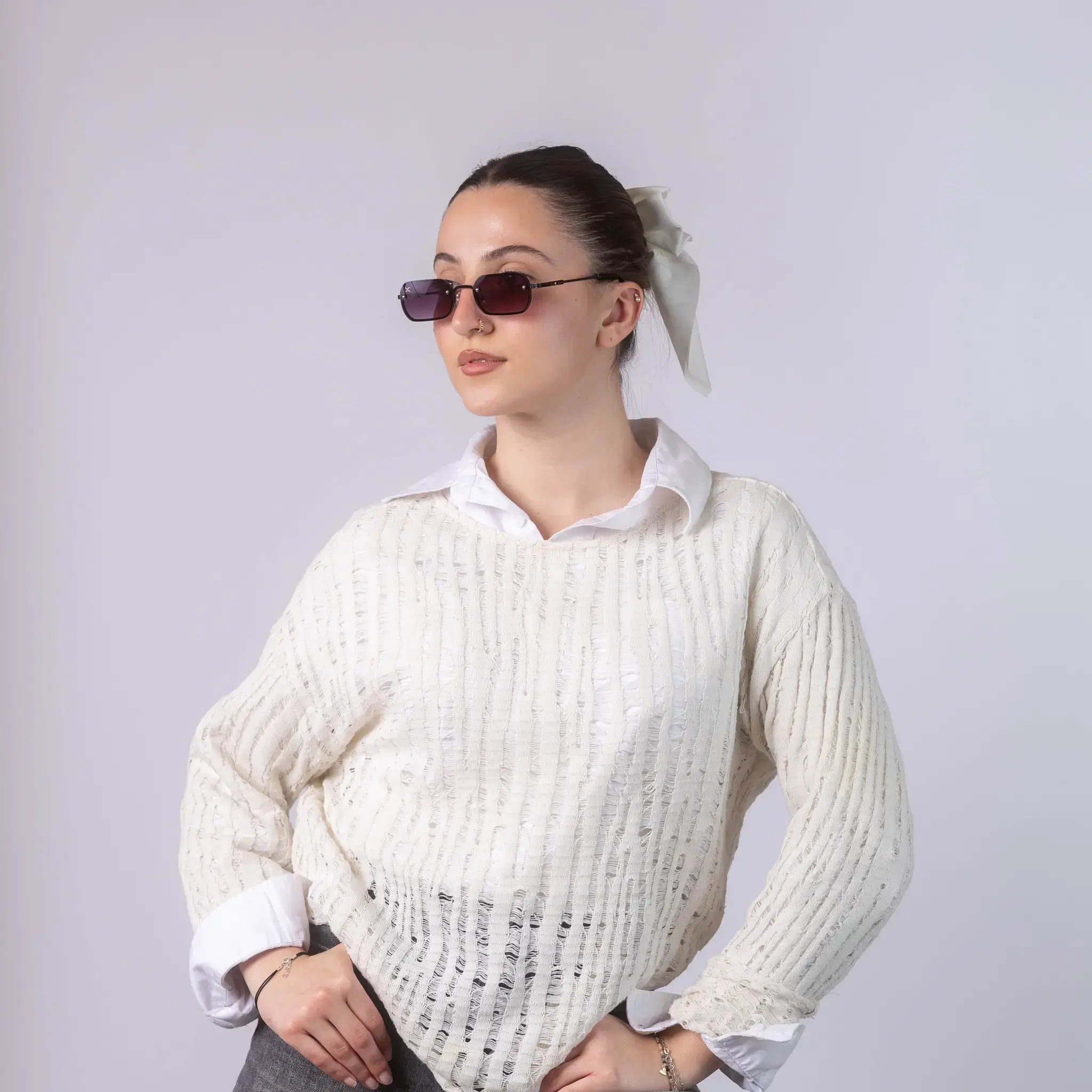 A female model wearing Exposure Sunglasses polarized sunglasses with black frames and purple lenses, posing against a white background.