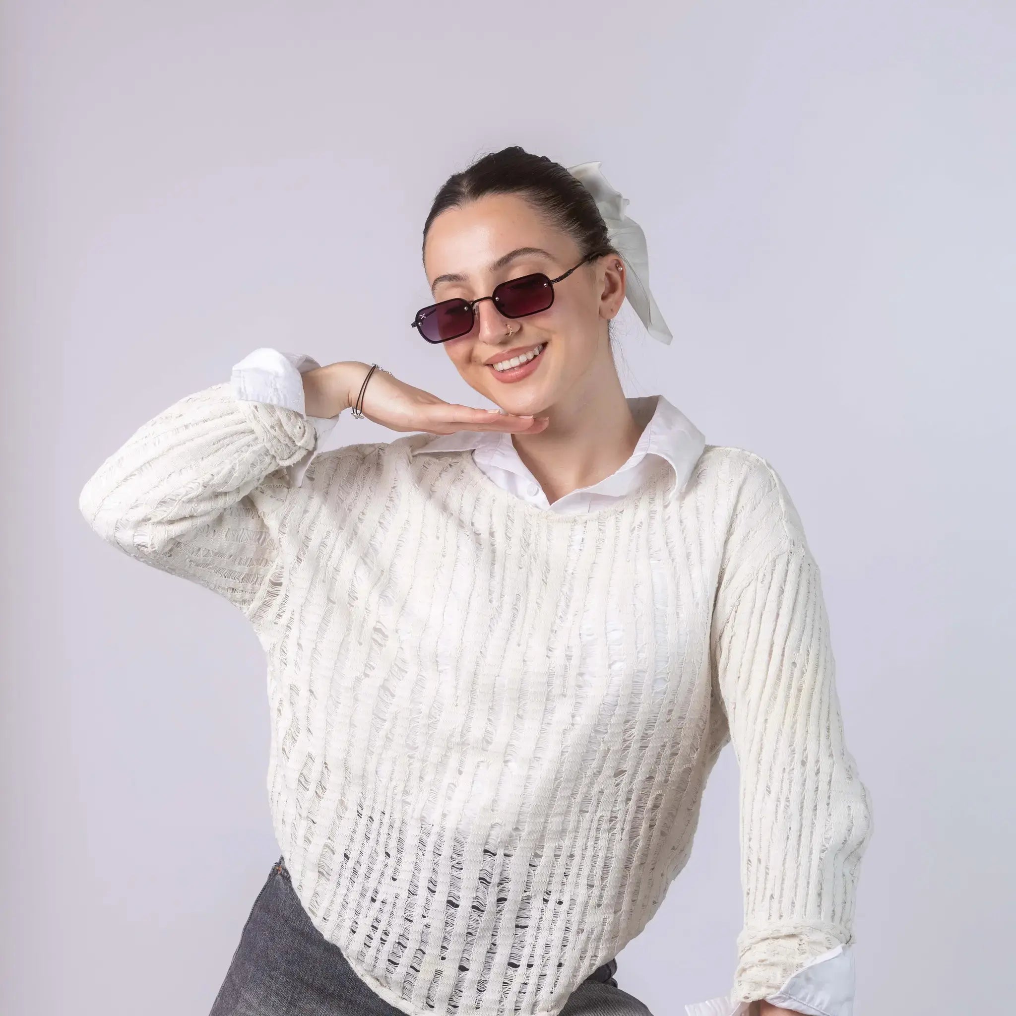 A female model wearing Exposure Sunglasses polarized sunglasses with black frames and purple lenses, posing against a white background.