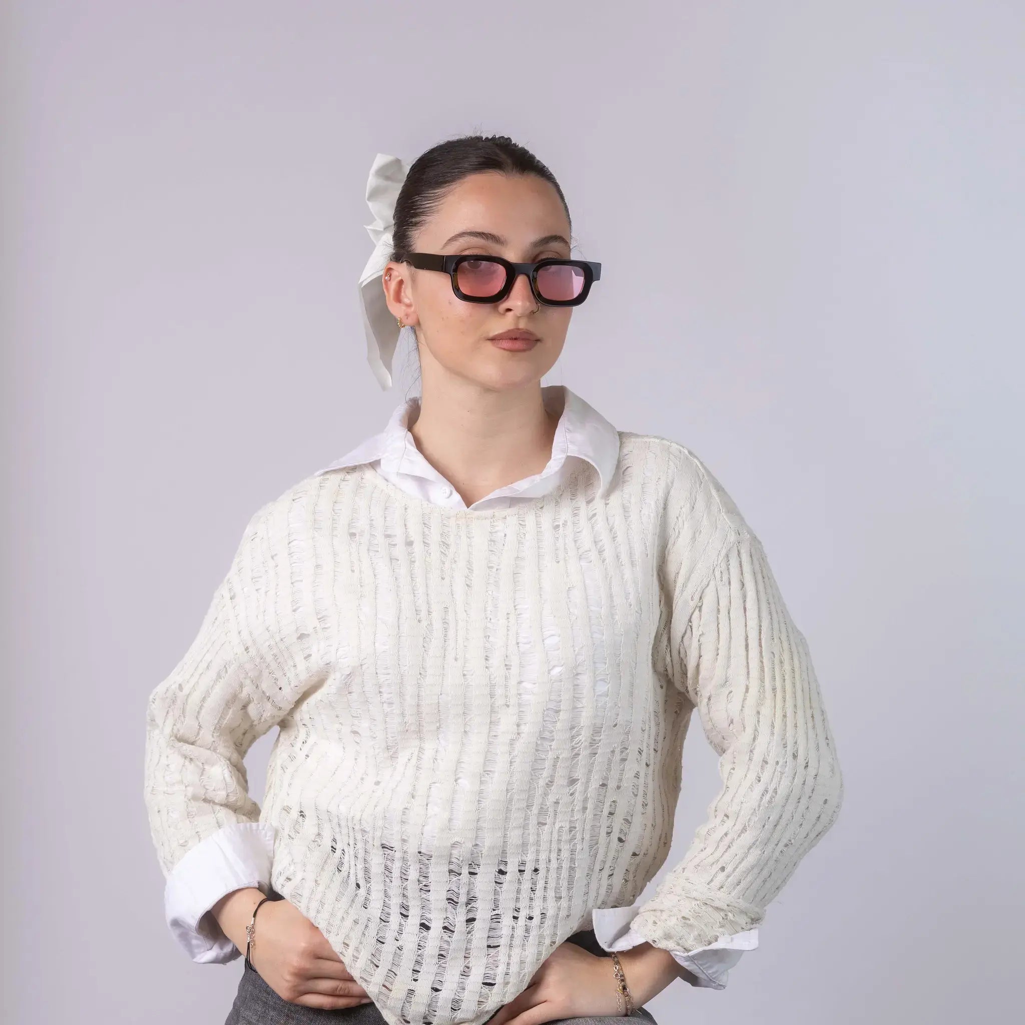 A female model wearing Exposure Sunglasses polarized sunglasses with black frames and pink lenses, posing against a white background.