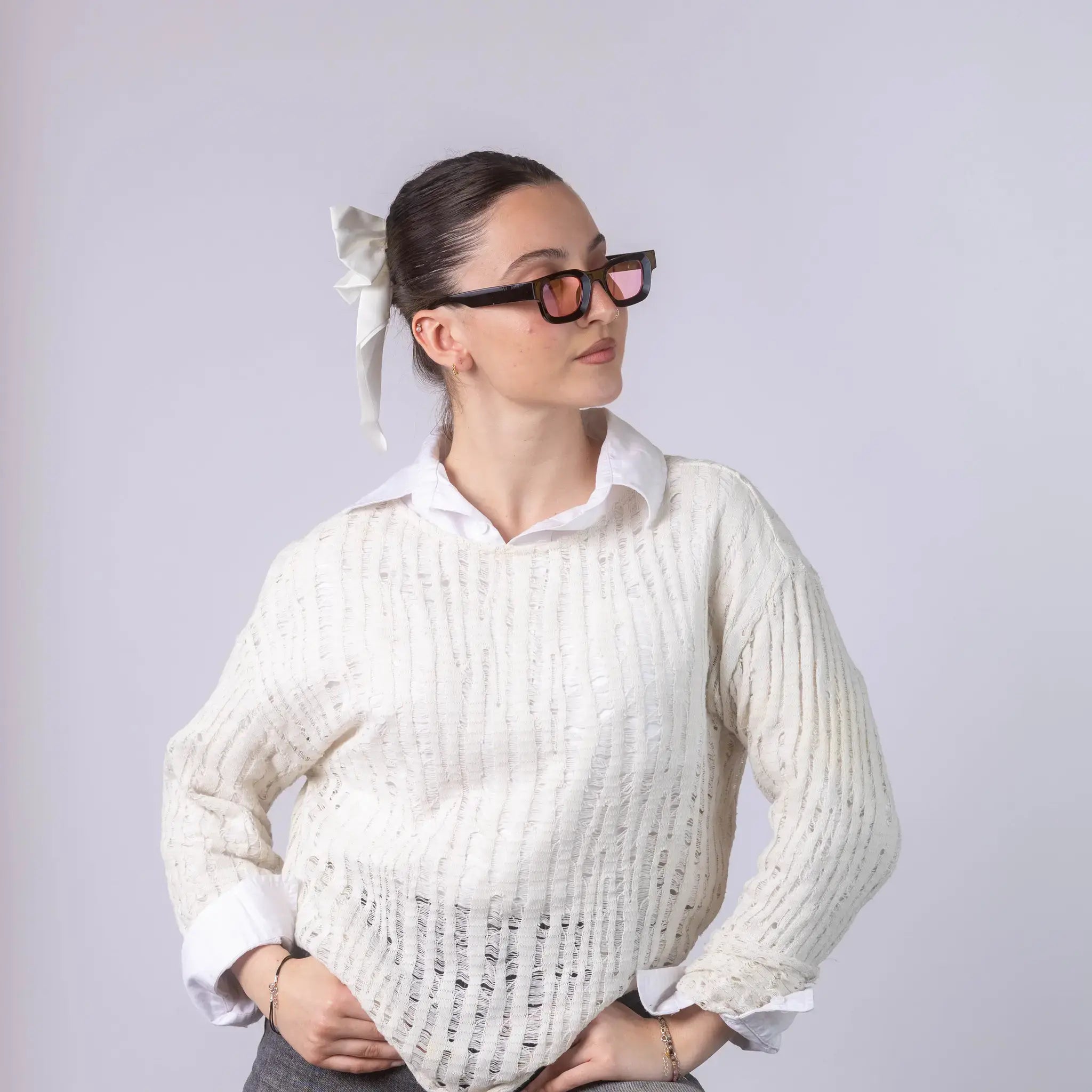 A female model wearing Exposure Sunglasses polarized sunglasses with black frames and pink lenses, posing against a white background.