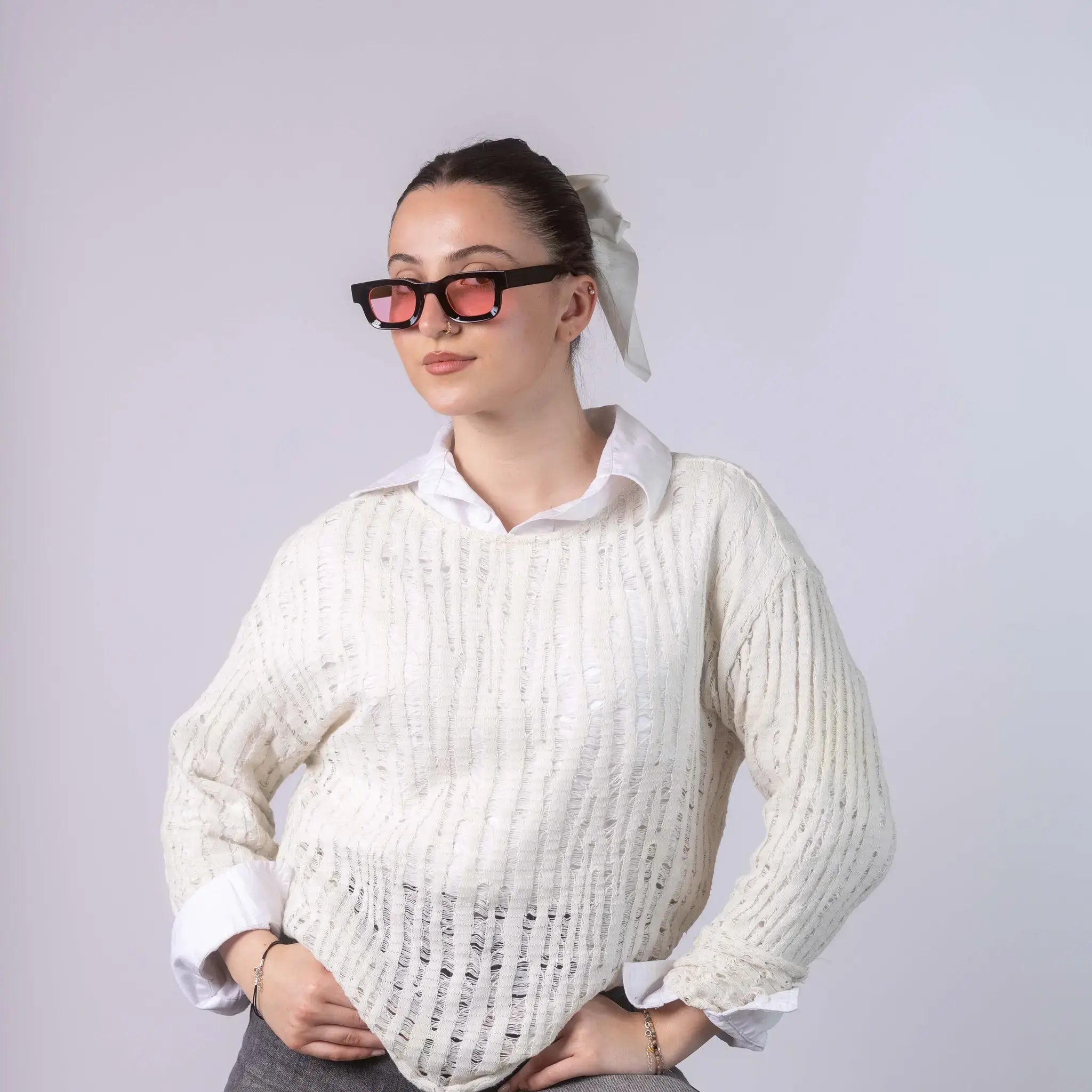 A female model wearing Exposure Sunglasses polarized sunglasses with black frames and pink lenses, posing against a white background.