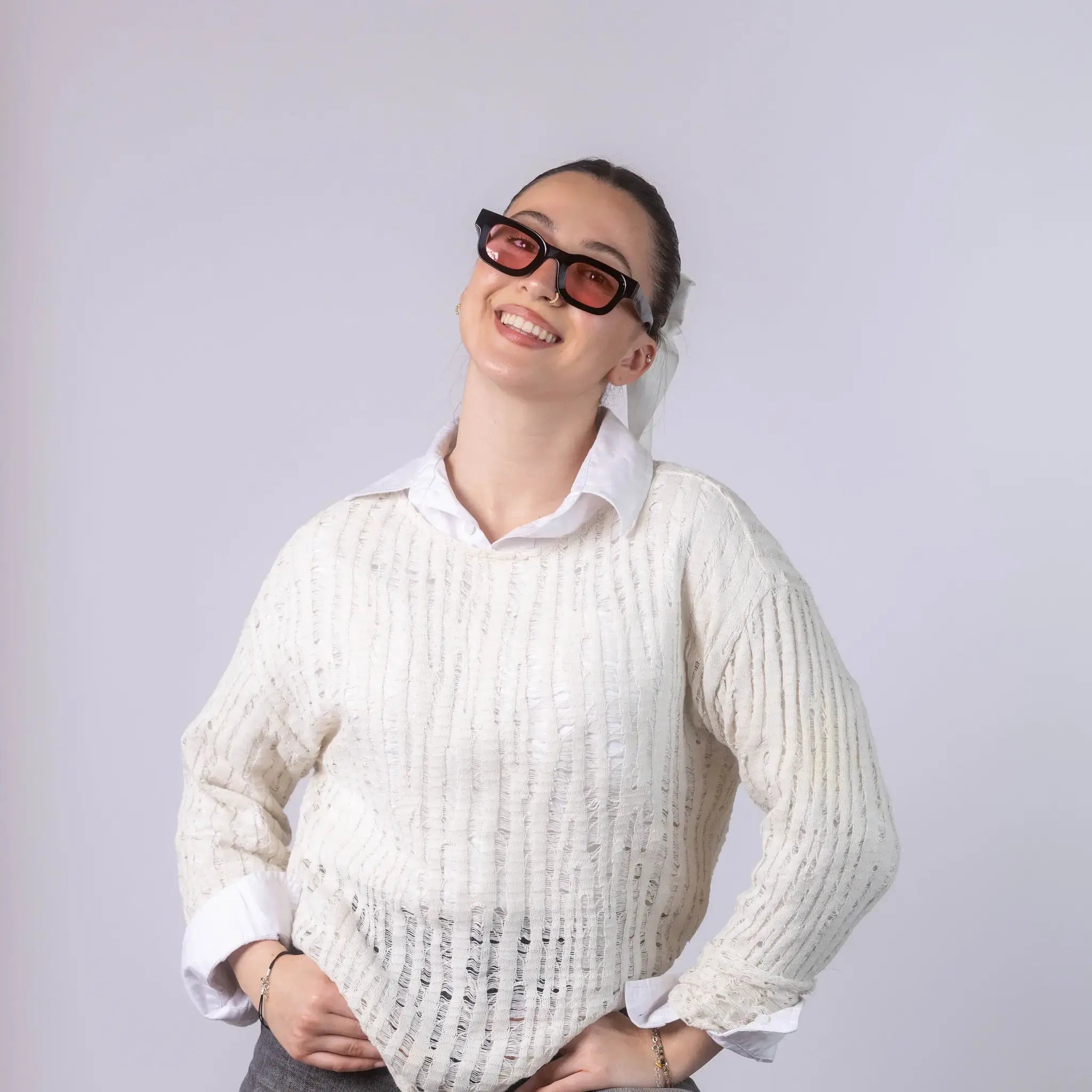 A female model wearing Exposure Sunglasses polarized sunglasses with black frames and pink lenses, posing against a white background.