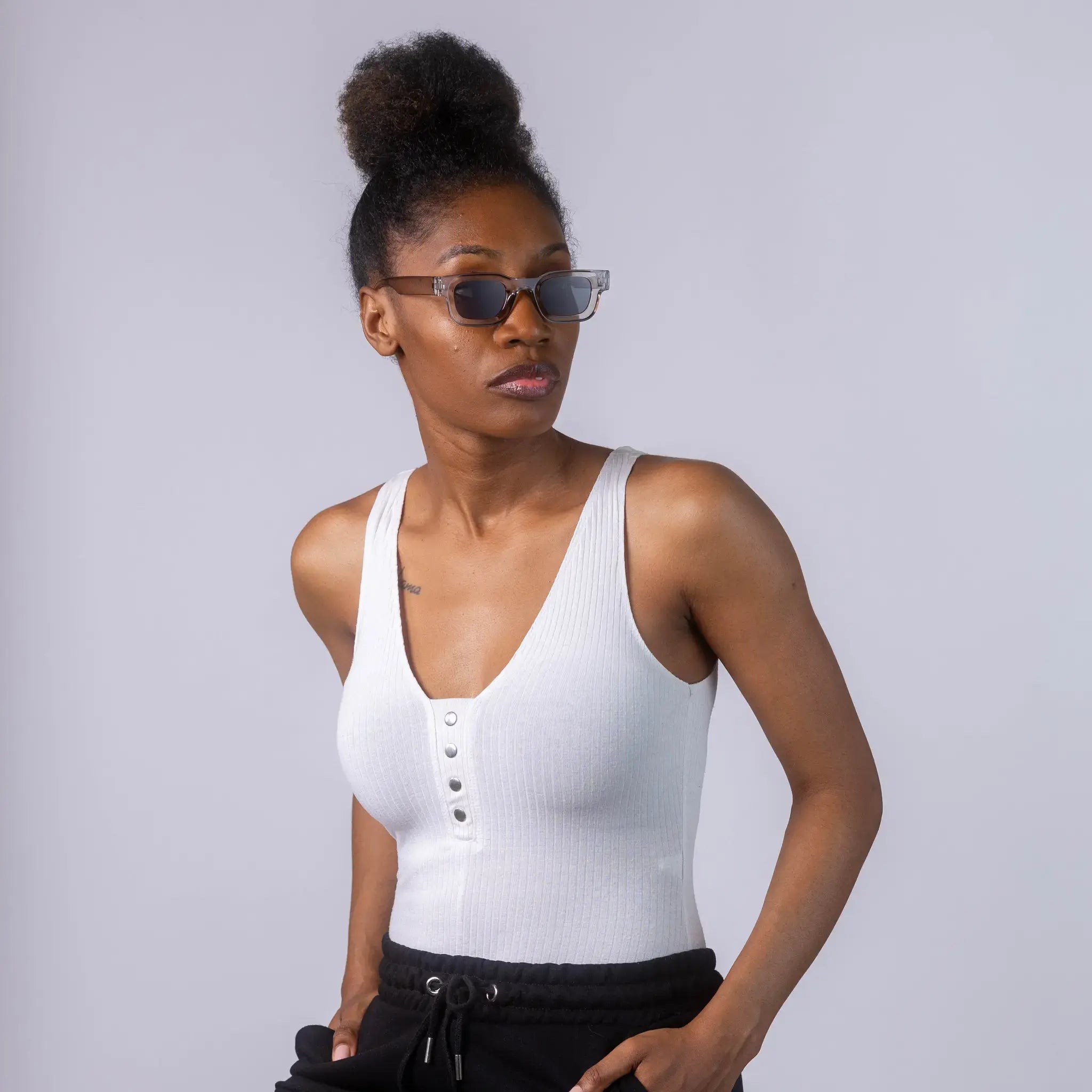 A female model wearing Exposure Sunglasses polarized sunglasses with silver frames and black lenses, posing against a white background.