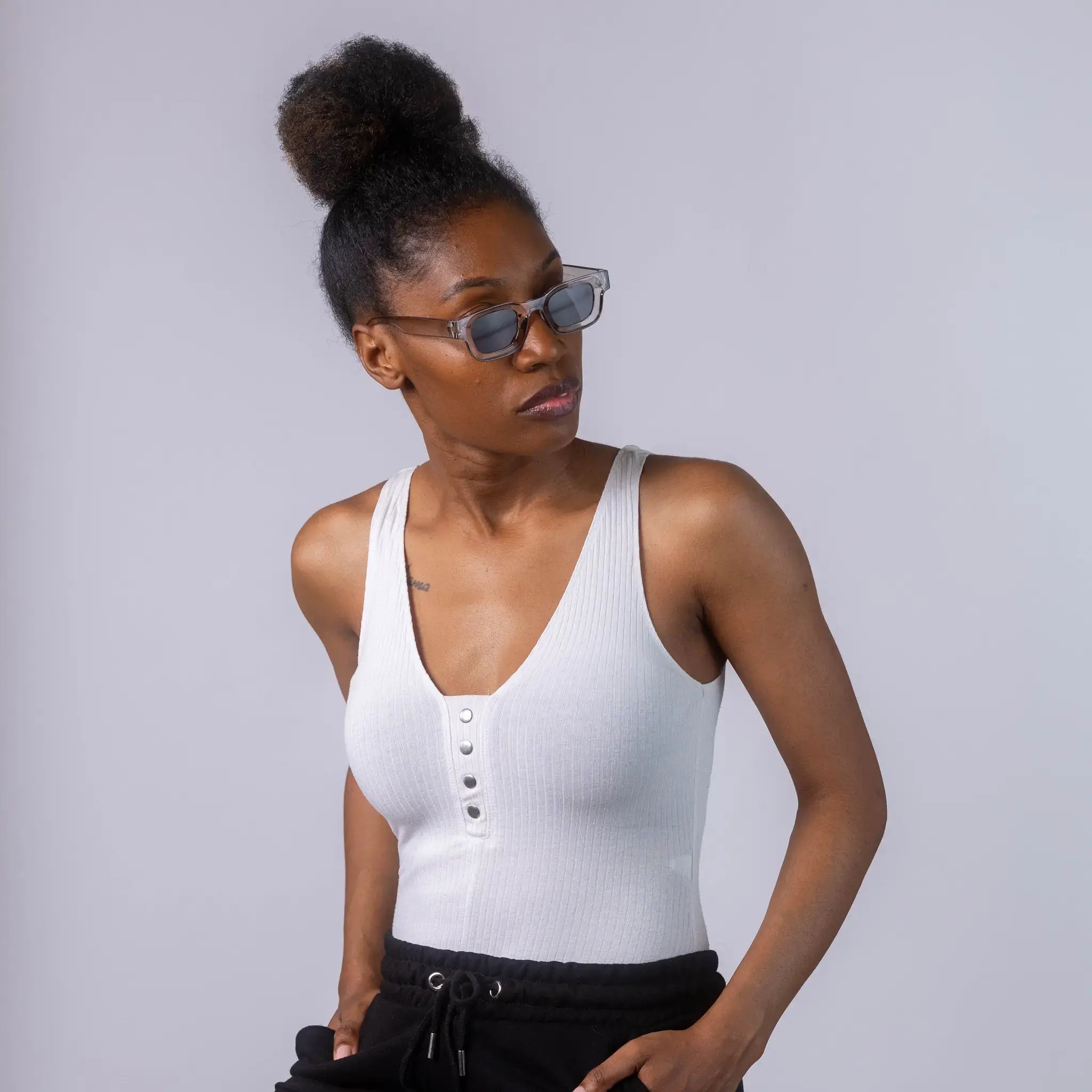 A female model wearing Exposure Sunglasses polarized sunglasses with silver frames and black lenses, posing against a white background.