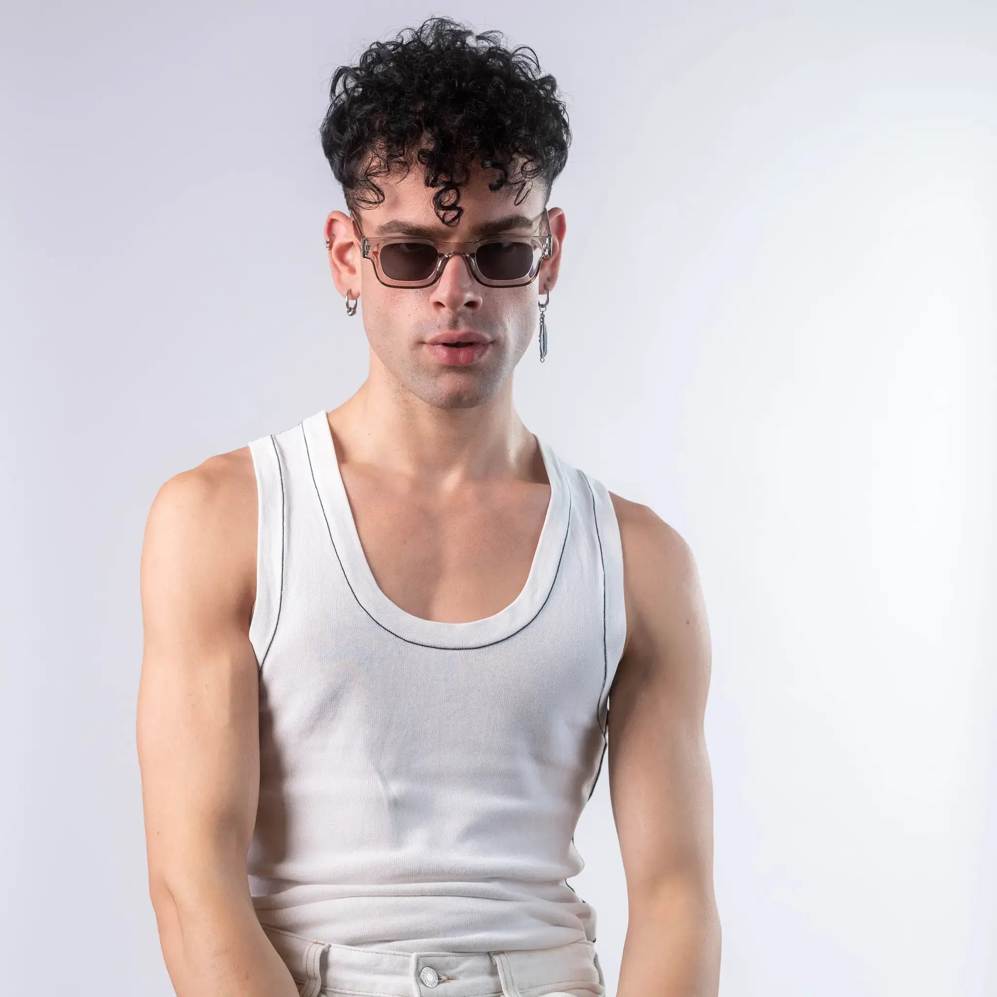 A male model wearing Exposure Sunglasses polarized sunglasses with silver frames and black lenses, posing against a white background.