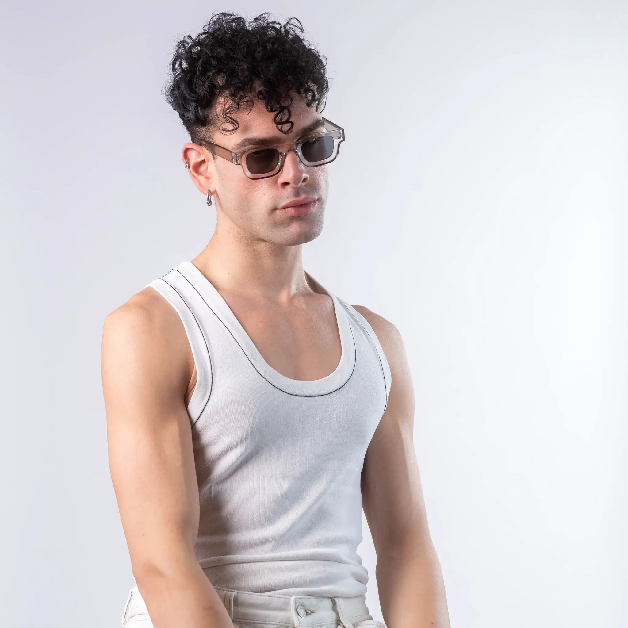 A male model wearing Exposure Sunglasses polarized sunglasses with silver frames and black lenses, posing against a white background.