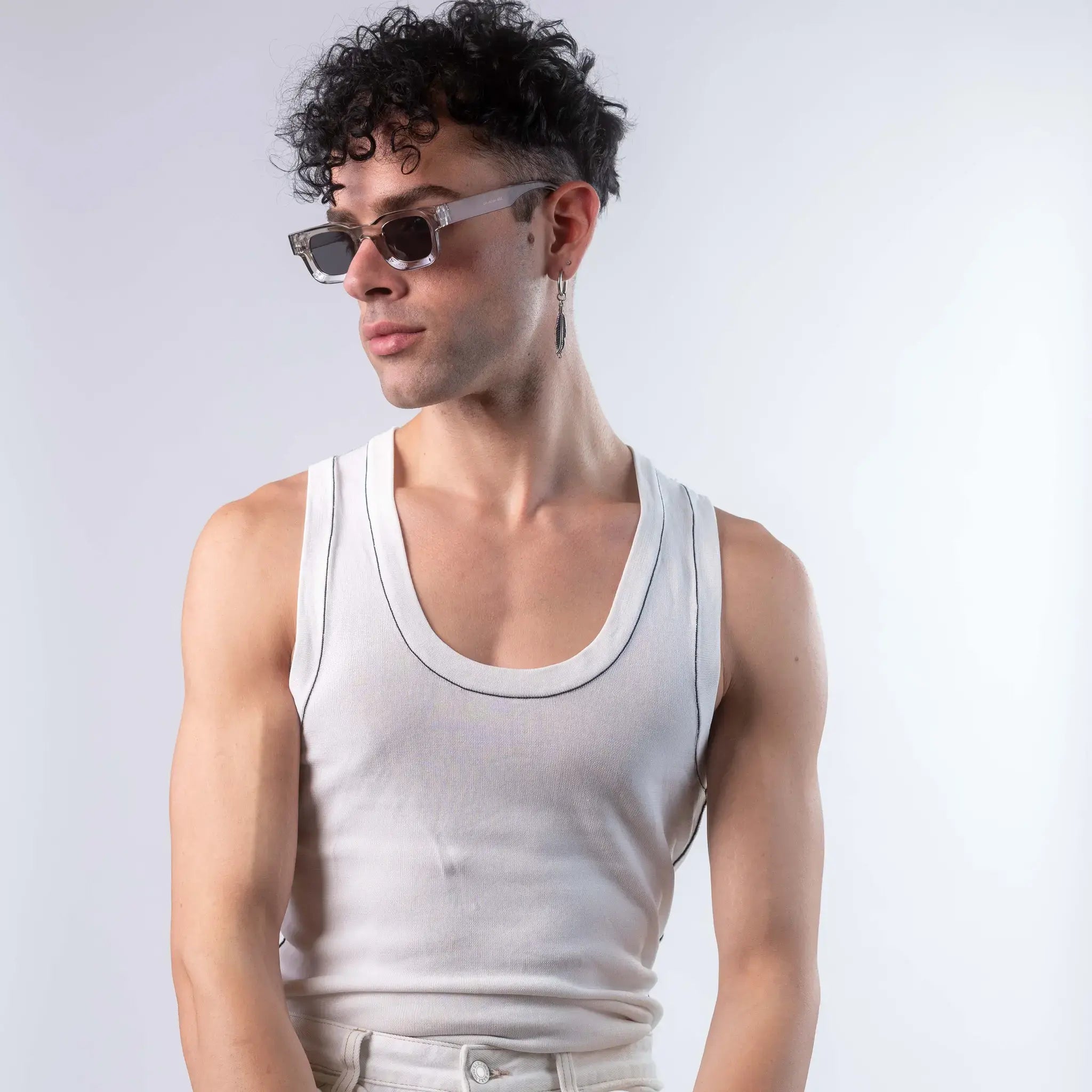 A male model wearing Exposure Sunglasses polarized sunglasses with silver frames and black lenses, posing against a white background.