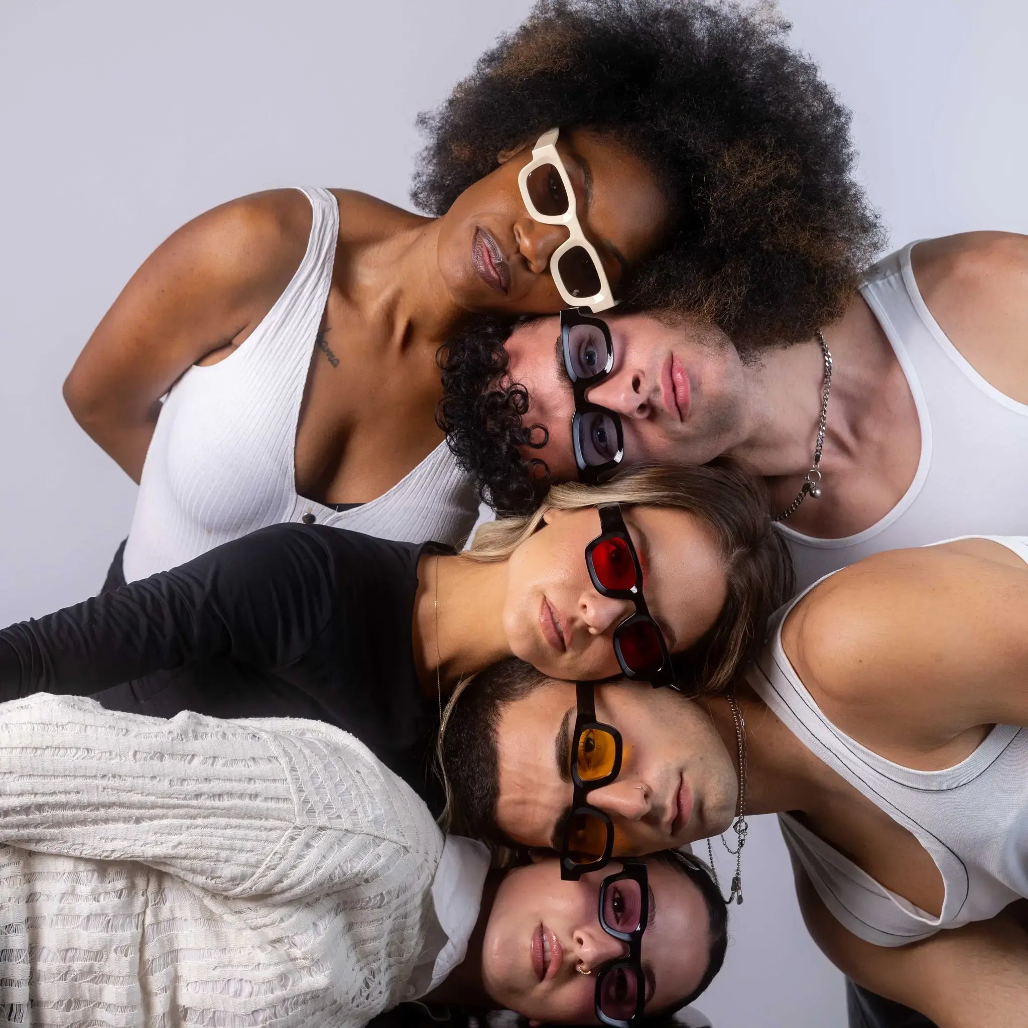 Five models wearing Exposure Sunglasses polarized sunglasses with black frames and tinted lenses, posing against a white background.