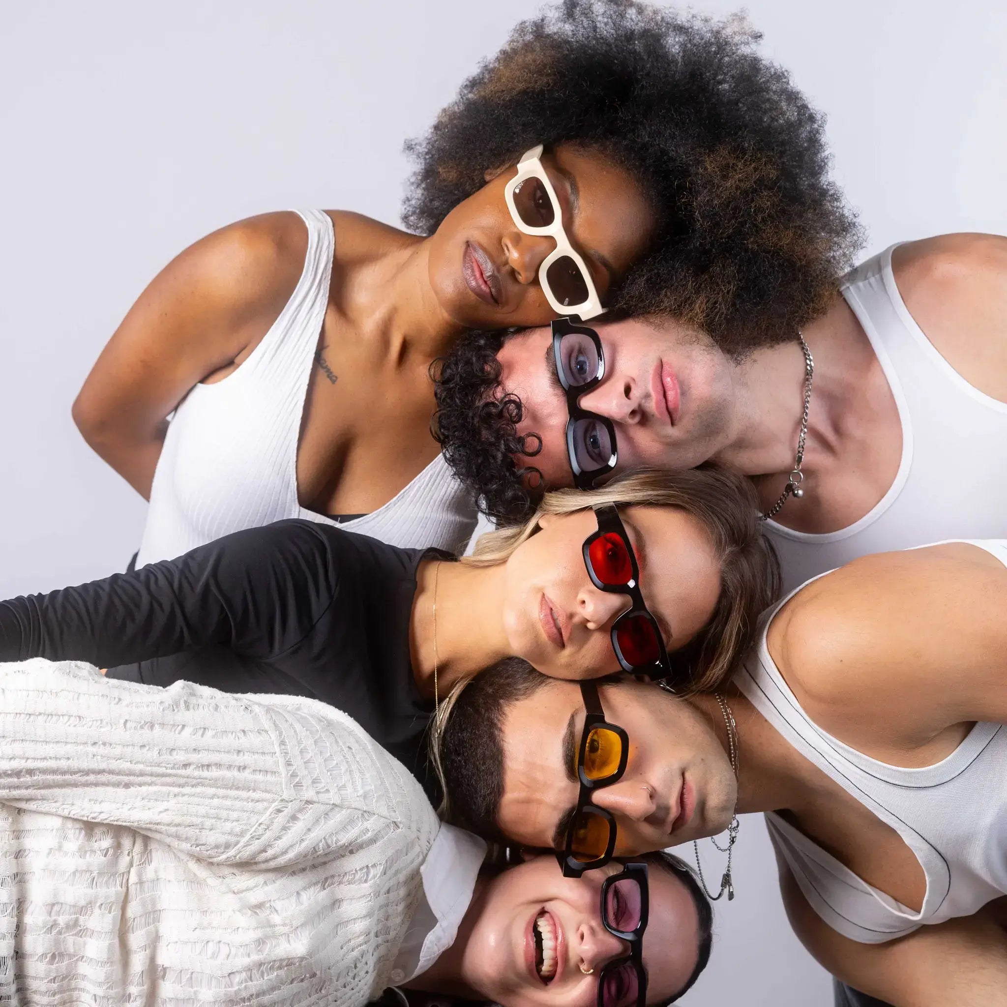 Five models wearing Exposure Sunglasses polarized sunglasses with black frames and tinted lenses, posing against a white background.